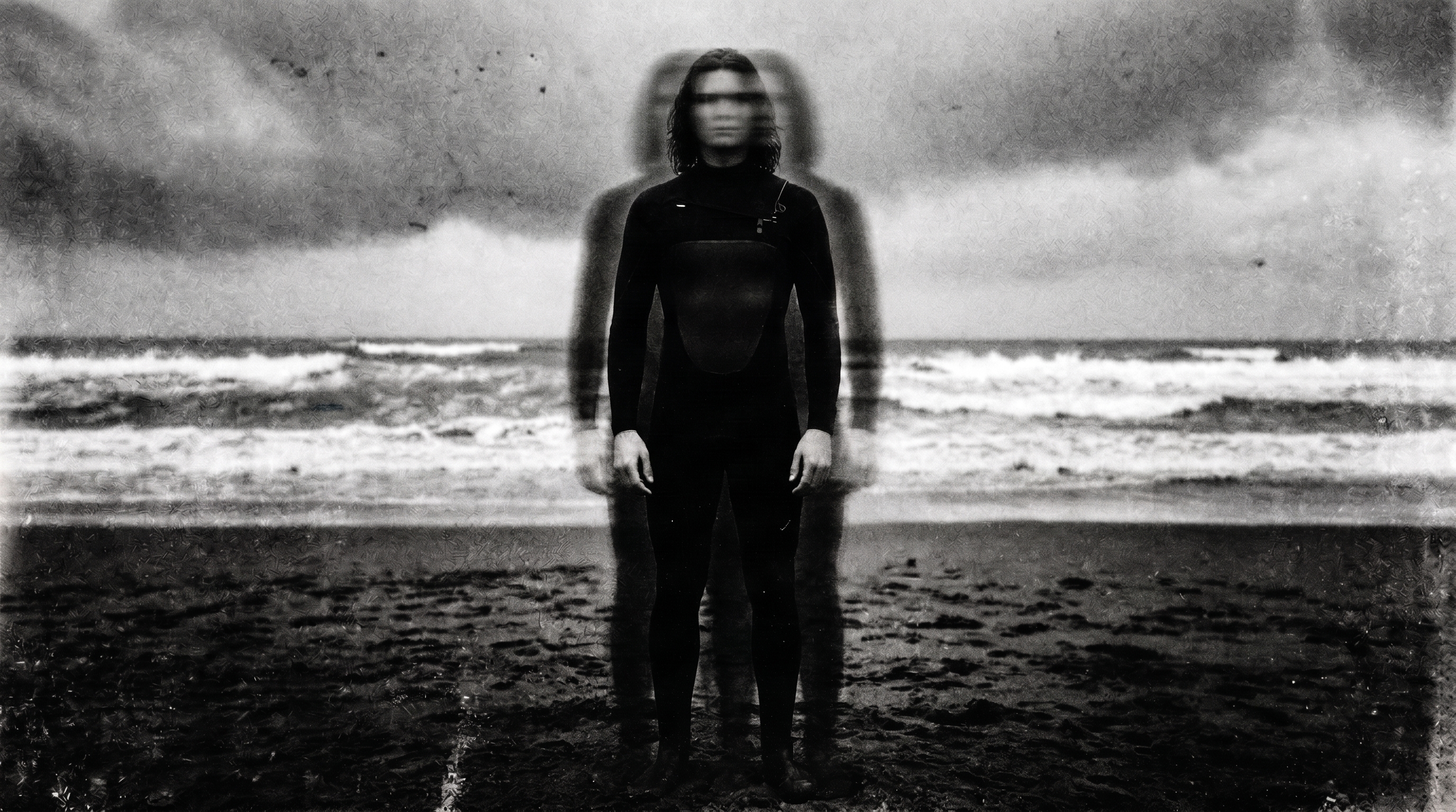 Surfer standing on the shoreline